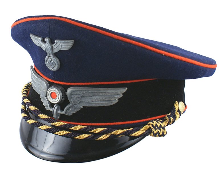 German WWII Reichsbahn peaked cap 2nd type: E-153 German WWII Reichsbahn - 2nd type peaked cap. Blue body with a black velvet band and red piping. Dark blue/yellow-gold chincord. Political type eagle and a large winged wheel holding a rosette. 