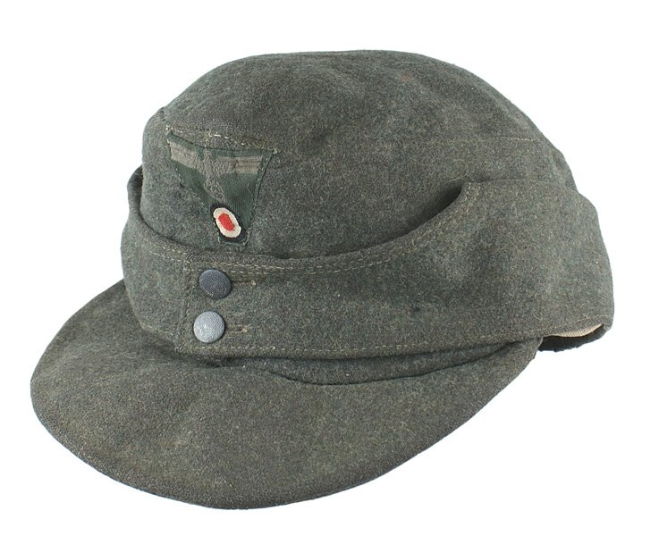 German WWII Army M1943 EM cap: E-158 German WWII Army M1943 EM cap. OD wool with a two-button front and pull down ear covers. Machine sewn bevo eagle/swastika/rosette trapezoid insignia. Lining has stamped issue numbers and size "5