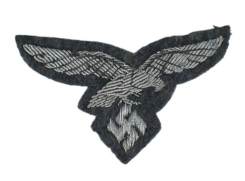 Luftwaffe officer peaked cap eagle: E-240 German WWII Luftwaffe officer's peaked cap embroidered eagle. Relief silver bullion flying eagle/swastika on a blue-gray background. Paper backing. II