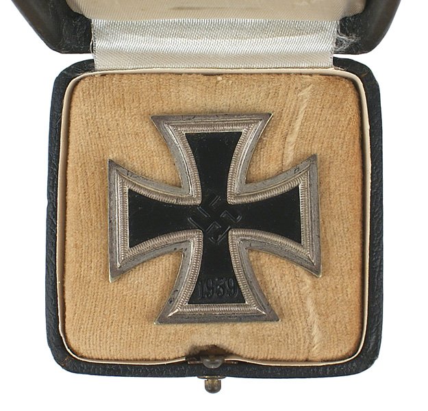 German WWII 1939 Iron Cross 1st Class Medal: B-88 1939 Iron Cross. 1st Class. Some patina on the silver frame. Wide pin marked "L/15" (Friedrich Orth in Vienna). Domed black leatherette case with an outline of the award on the lid. White silk an
