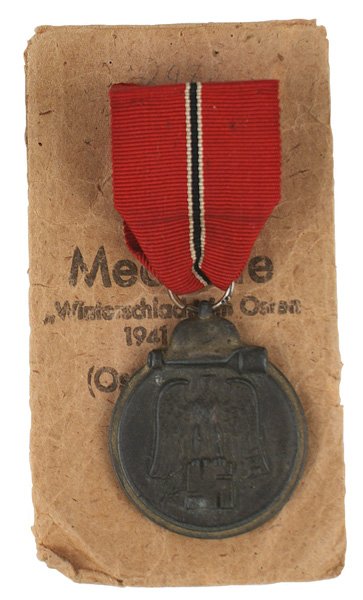 German WWII Eastern Front Medal: B-113 German WWII Eastern Front Medal. Marked ring not discernible. Patina on medal. With a "Friedrich Orth-Wien..." packet envelope (split on side). II-