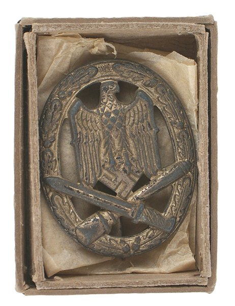 German WWII General Assault Badge Silver: B-129 General Assault Badge - Silver - solid type, open oak leaf wreath holding an eagle/swastika over a crossed bayonet/stick grenade. 50% of the finish remains. Aged reverse. Round pin. With a cardb
