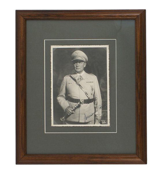 Ink signed Hermann Goring photo portrait postcard: A-14 Ink signed "Hermann Goring" photo portrait postcard. The Field Marshall is wearing his decorations and holding his FM baton. Professionally matted and framed. Overall, 11" x 9". II+