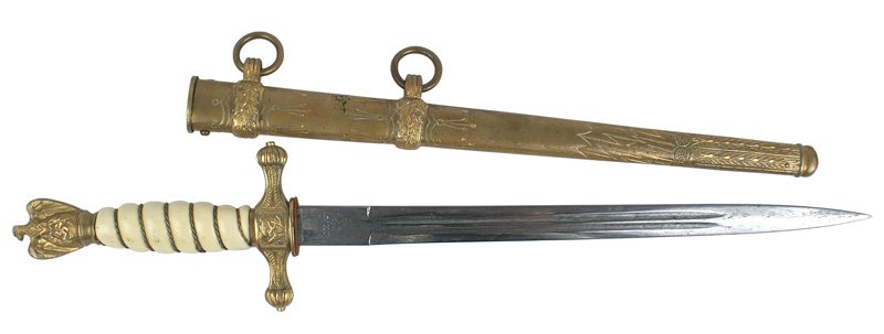German WWII Navy dagger: D-26 German WWII Navy dagger. Twisted gold wire wrapped off-white grip. "WKC" marked plain blade which is starting to gray and has some minute pitting. Engraved two-ring brass scabbard. About II