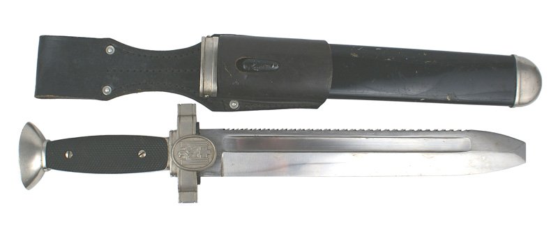 German WWII Red Cross hewer dagger: D-34 German WWII Red Cross hewer dagger. Nickeled pommel and relief eagle/swastika/red cross on crossguard. Black plastic grips. Excellent, wide, 10 1/2" blade with a sawback spine. Nickeled fittings 