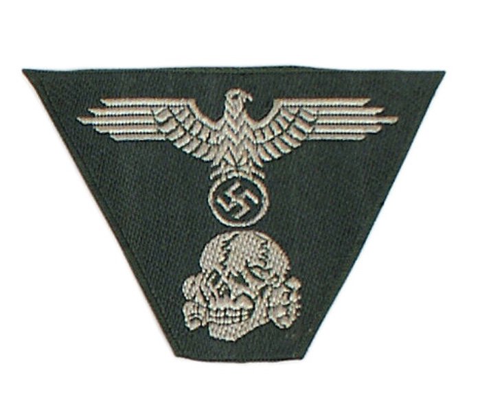 German WWII Waffen-SS M43 cap insignia: H-151 Waffen-SS M-43 bevo embroidered cap insignia. O.D. trapezoid with silver-gray eagle/swastika and skull. I