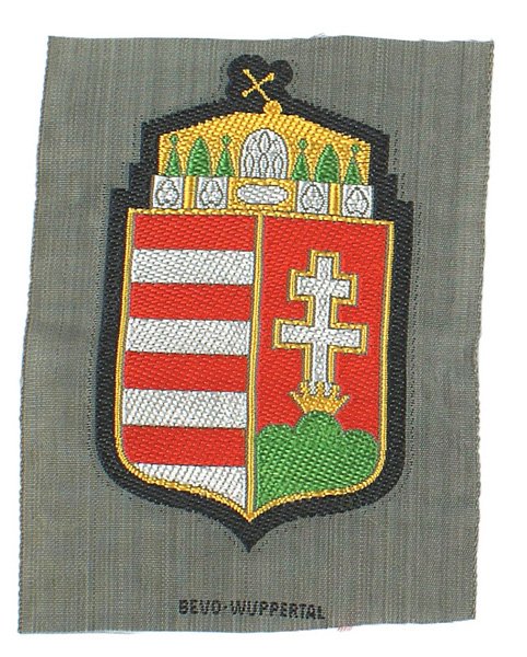 German WWII Hungarian arm shield: H-160 Hungarian volunteer arm shield. Elaborate National coat-of-arms. Uncut. Marked "BEVO WUPPERTAL". I