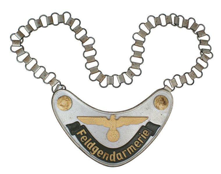 German WWII Feldgendarmerie gorget: H-194 Army "Feldgendarmerie" gorget. Luminous large eagle/swastika and corner domed "bosses" applied, with a legend with lettering on a silver-gray iron crescent. Reverse has two long uniform hooks, o