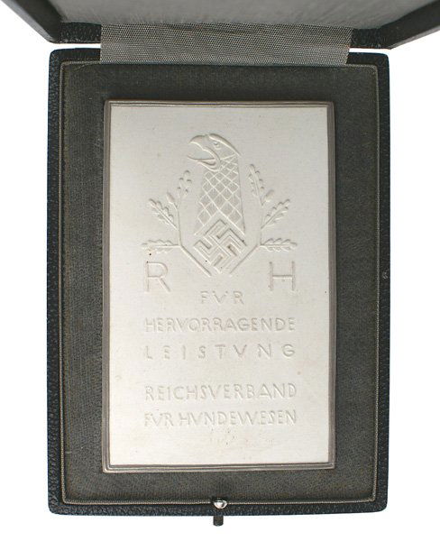 German WWII plaque dog breeding: H-199 Cased presentation plaque for the breeding of dogs. Silver bordered 3 7/8"x2 3/8" white porcelain with an eagle's head/swastika "RH" and wording. Made by "KPM". Black leatherette case with gray