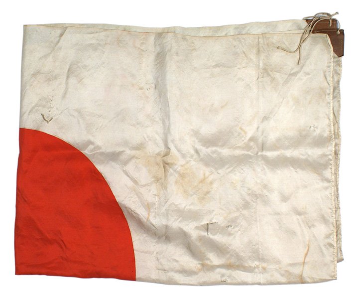 Japanese WWII meatball flag: H-234 Silk Japanese "meatball" flag. Paper tabs and string ties in two corners. 27 1/2" x 38". Two small tears and soiling. II