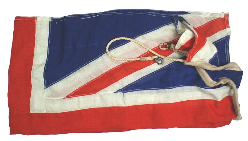 British Union Jack flag: H-276 British Union Jack. Multiple-piece construction. Brass hooks/rope on corners of the reinforced sleeve. Has two gromets and is stamped with the name of the maker. "W. COCKSHAW LTD. - LEEDS" and i