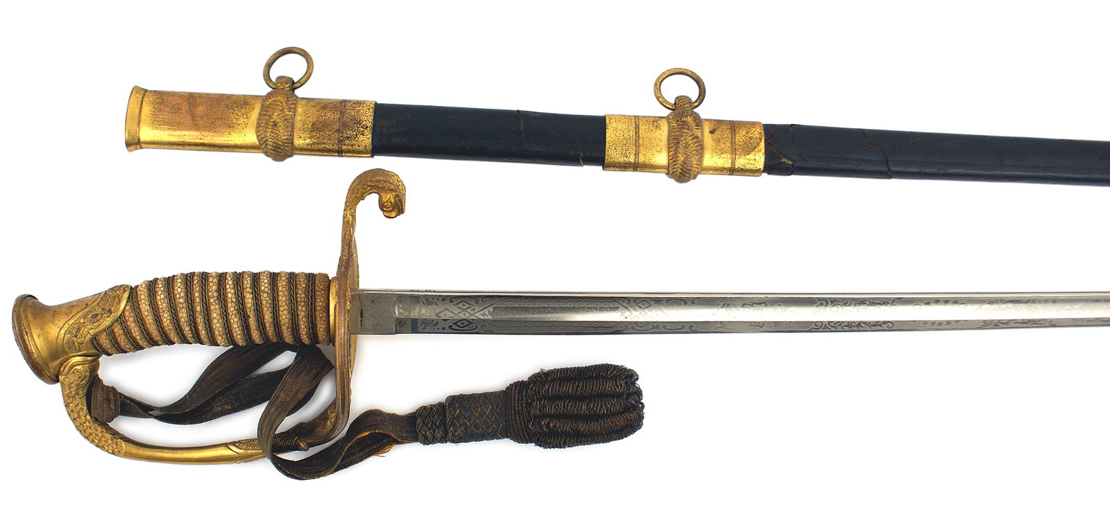 US Navy M1852 officer dress sword: K-026 U.S. Navy M1852 officer's dress sword. "Smokey" gold finish on the decorative pommel, reverse "D" knuckle-bow and floral "USN" guard. Gold wire wrapped white sharkskin grip. 28" clean ethched