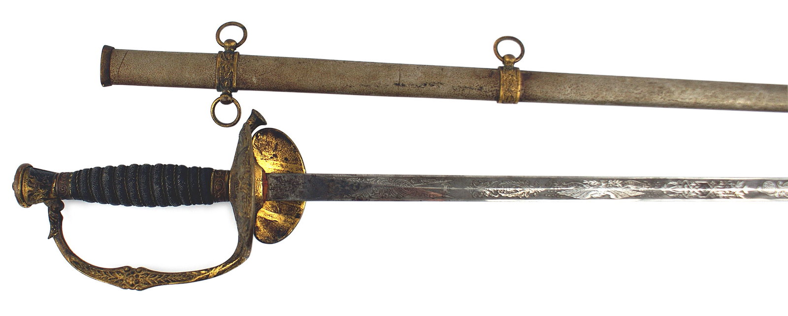 US M1860 Staff Field officer sword: K-027 American M1860 staff and Field Officers sword. Gilt washed brass pommel with a relief eagle, shield, leaves and berries. A patina on the floral knuckle-bow, guard, with an American eagle and fla