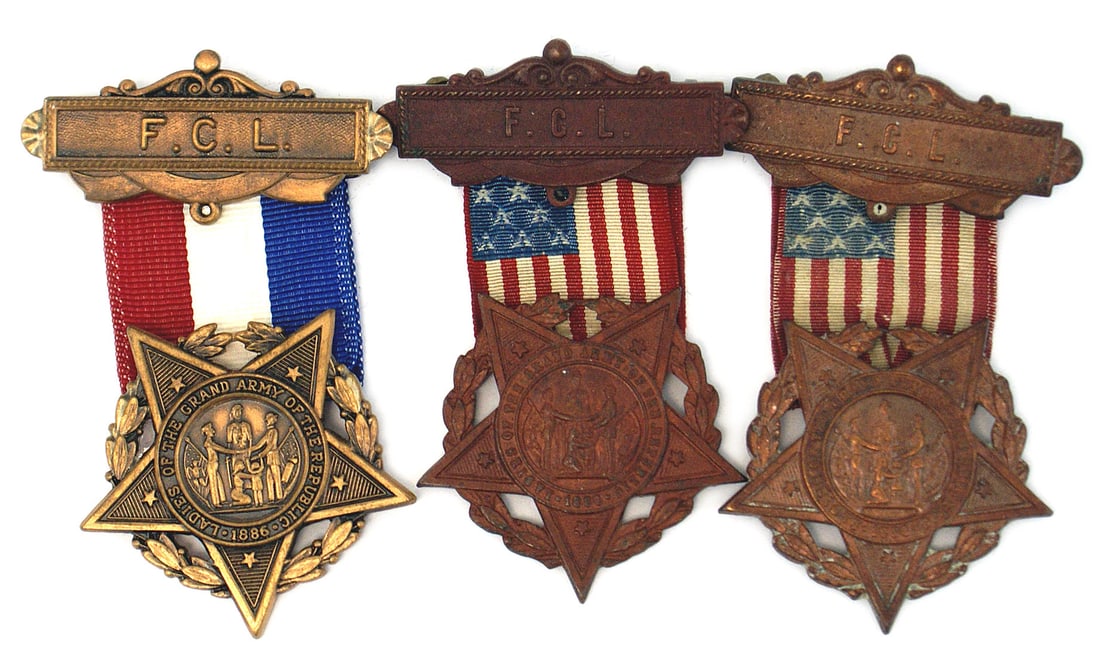 3 LADIES of the GAR Member Badges: K-089 Lot of 3 "LADIES of the Grand Army of the REPUBLIC" Member's Badges. Bronze GAR type star on oak leaf wreath. Two have an American flag ribbon suspended from a bronze pin-back pendant, with "F.C
