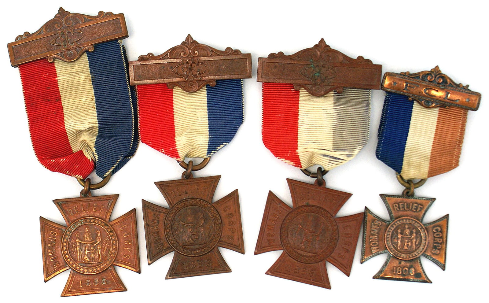 4 Civil War membership badges WOMENS RELIEF CORPS: K-091 Lot of 4 US membership badges for the "WOMEN'S RELIEF CORPS": (1) Bronze Form/Paty Cross with title of organization on arms of cross and center roundel scene similar to the GAR. Red/white/blue r