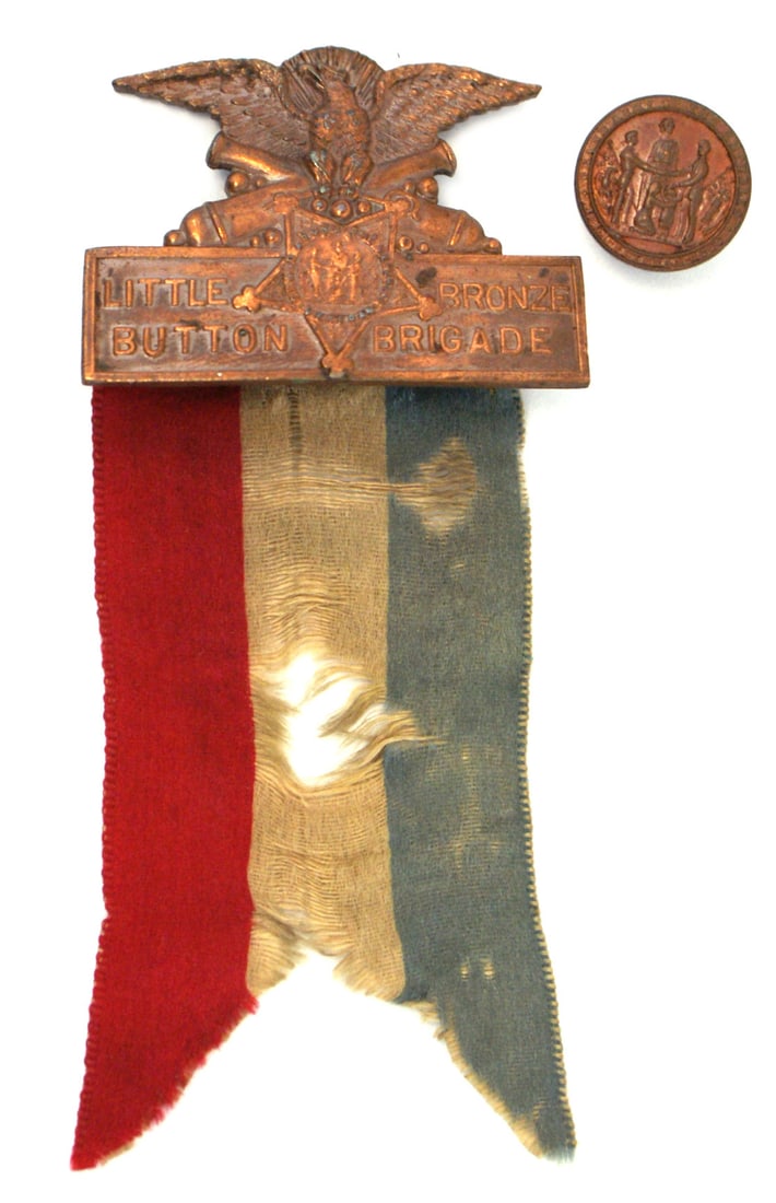 Civil War Little Bronze Button Brigade Badge: K-092 Little Bronze Button Brigade Badge, Large pin-back pendant of an eagle, crossed cannons, GAR star and "LITTLE BRONZE BUTTON BRIGADE". With a swallow-tail red/white/blue ribbon (shows wear). Also