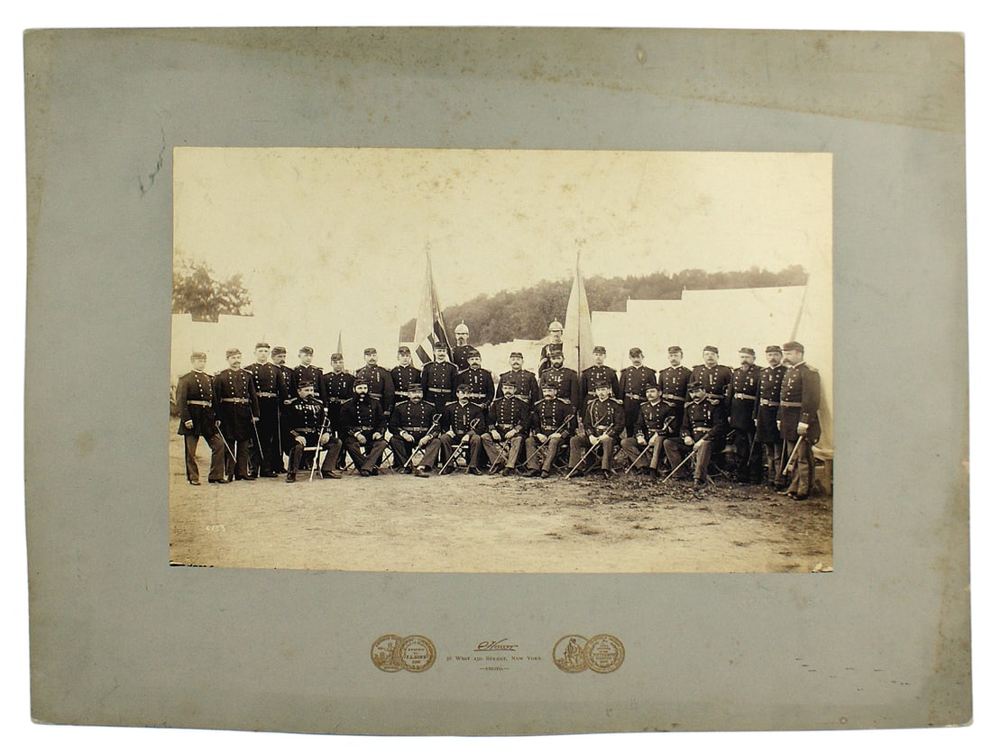 Photo of US Indian Wars military unit: K-102 Large photo of the officers of an Indian Wars military unit. A total of 30 standing and seated officers, wearing their medals (many "ladderbacks") and swords. 9 1/2" x 14" mounted on a 16" x 20"