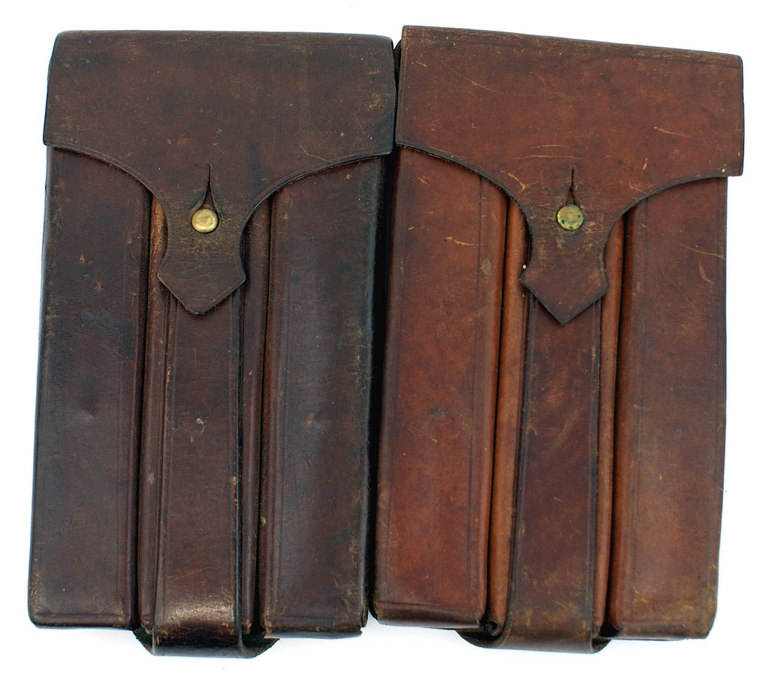 2 Austrian 1930's cartridge boxes: M-051 Lot of 2 Austrian 1930's slanted-type, double brown leather cartridge boxes. Leather belt loops and square brass loop on reverse. II