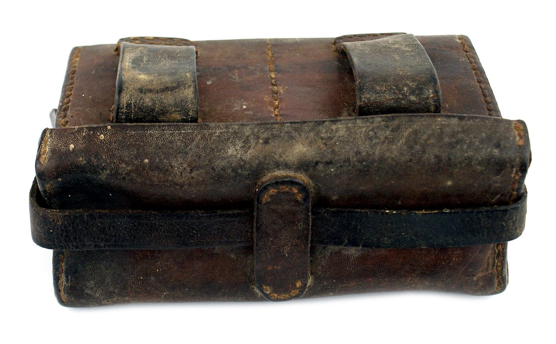 Japanese WWII leather ammunition pouch: M-056 Japanese WWII leather ammunition pouch, which holds six 5-round clips. Locking strap across top and two belt loops. Shows some wear. II