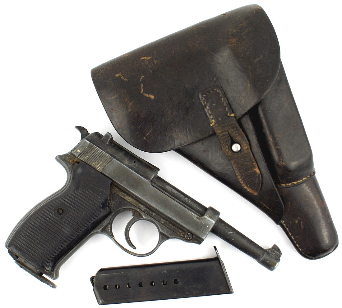 Post WWII model P38 pistol with holster: M-073 Post-WWII model P-38 pistol. Moving trigger. Slide, hammer and magazine. Left side has a logo with "BBM" and "MADE IN ITALY". Left plastic grip is cracked and repaired. Dark brown leather holste