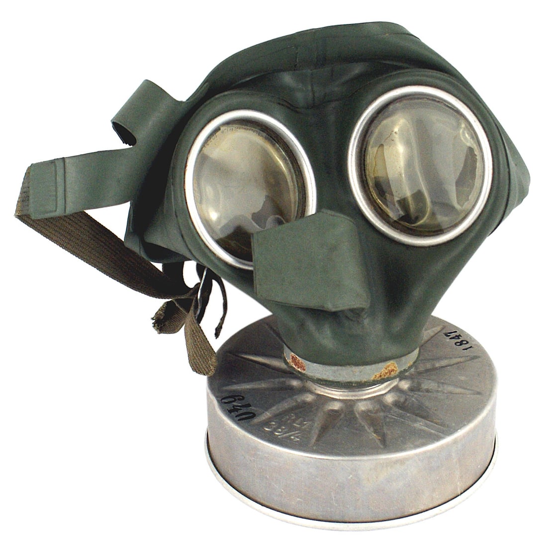 German WWII Luftschutz gas mask: N-004 German WWII Luftschutz gas mask. Issued to the civilian population. Rubber face mask with celluloid eye pieces. Aluminum flat "pancake" style filter. Well marked with issue numbers and stamped w
