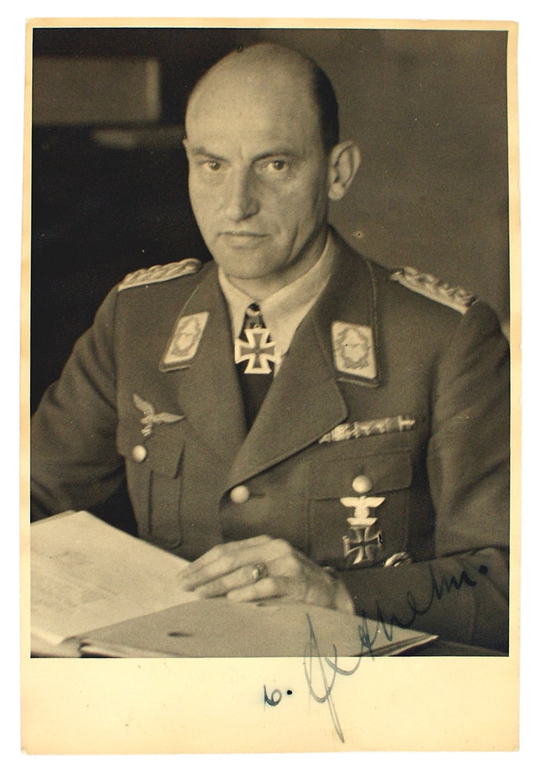 WWII autographed photo Luft. von Axthelm: L-010 WWII autographed 6 3/4" x 4 3/4" photo of Luftwaffe Maj. Gen. Walter von Axthelm seated at his desk. His Knight's Cross, 1st Class Iron and Spange are prominent. Blue ink signature in lower corn
