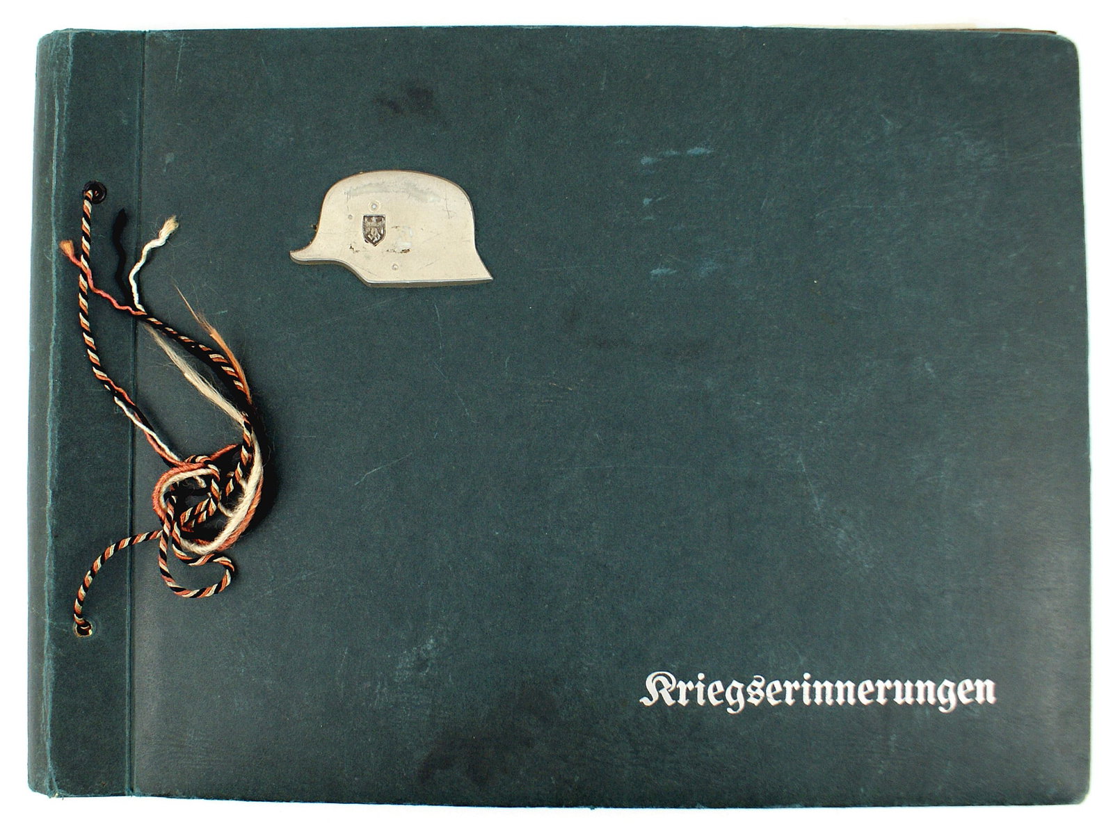 German WWII Army photo album: L-019 German WWII Army photo album. 10" x 13" simulated green leather cover with a 1 1/2" x 2 1/2" Army metal "stahlhelm" and "Kriegserinnerungen" in silver. 112 larger photos of officers, one on hors