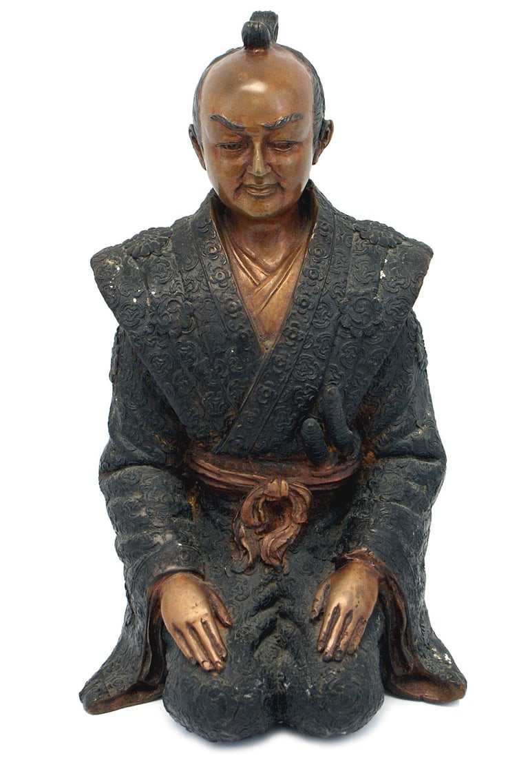 Antique bronze kneeling Samurai: G-005 Antique bronze of a kneeling Samurai. Well defined facial features and hairstyle of the period. The flowing robe covers a cuirass chest form and is embellished with a multitude of relief roses, 