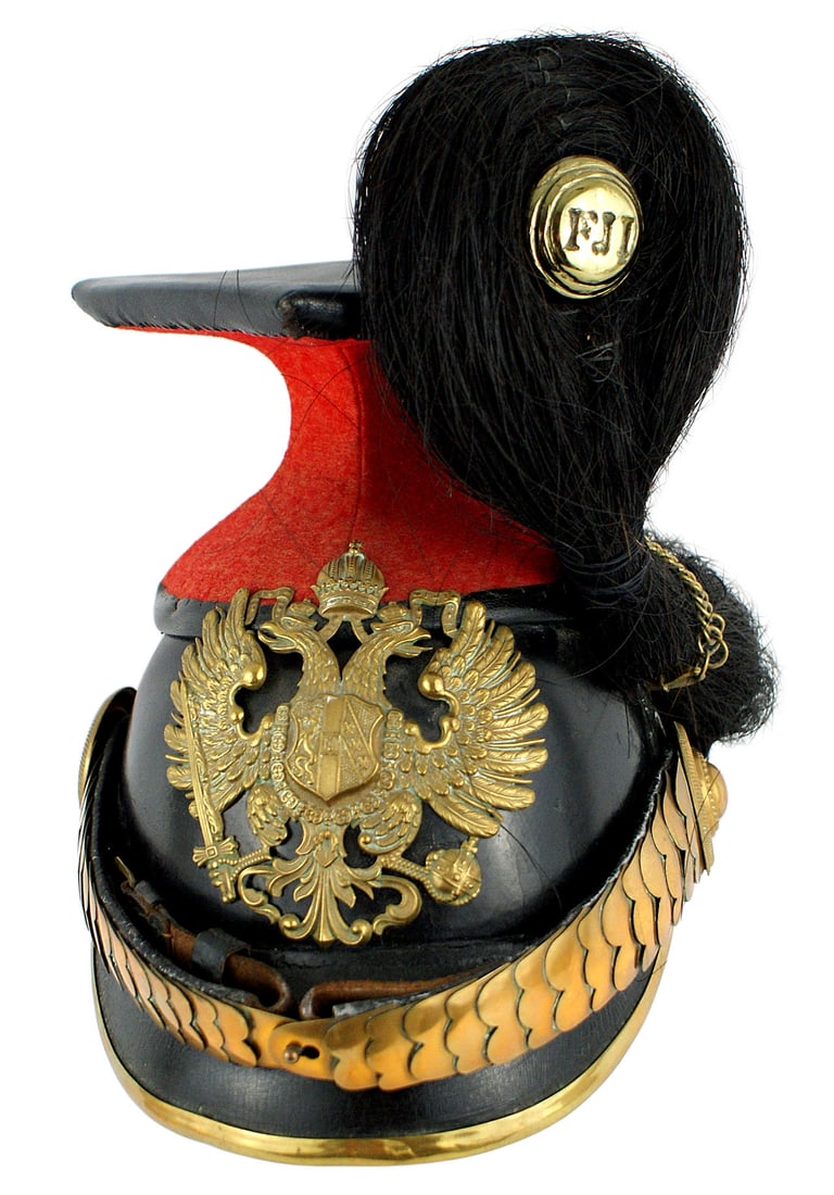 Imperial Austrian Uhlan helmet: E-001 Imperial Austrian Uhlan helmet. An interesting construction using an earlier helmet body, removing the back visor and adding an Uhlan base/stem/flat top. Solid black leather body and brass trimm