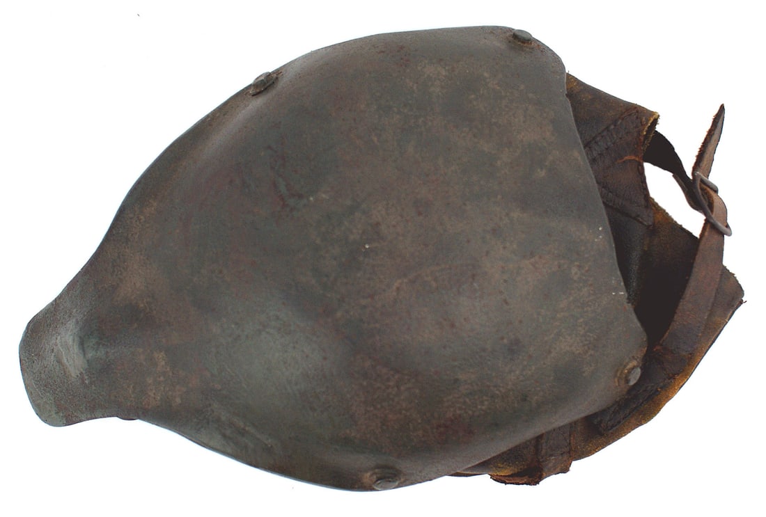 German WWI first modern military helmet: E-004 German WWI "Gaede", the first modern military helmet. Consists of steel, this innovation comprised a skull cap with an extended partial face/nose guard. The leather liner was attached with four 