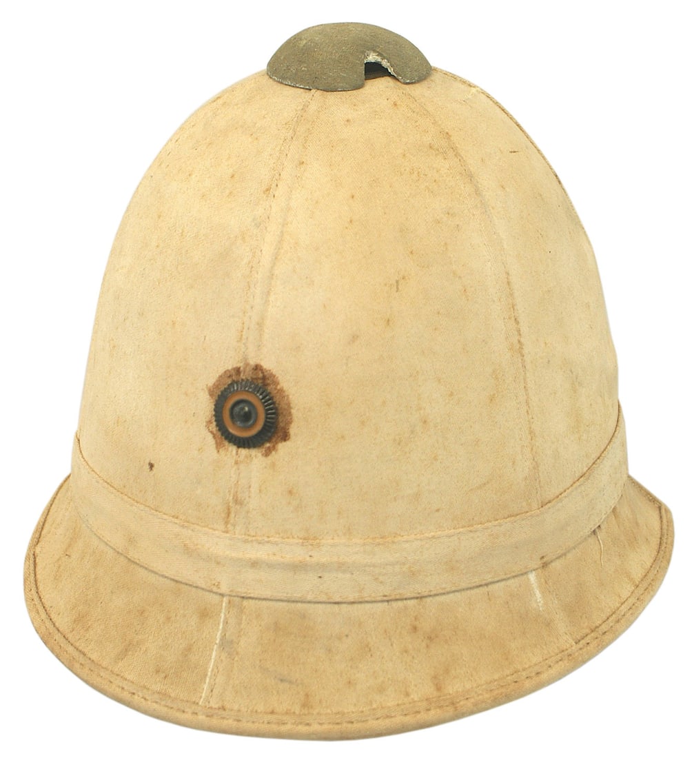 German WWI era Colonial Middle East pith helmet: E-014 German WWI era Colonial/Middle East melon shaped white pith helmet. Wurttemburg rosette on front - appears to be an early attachment. Body is age darkened with some foxing. Tan chinstrap with a 