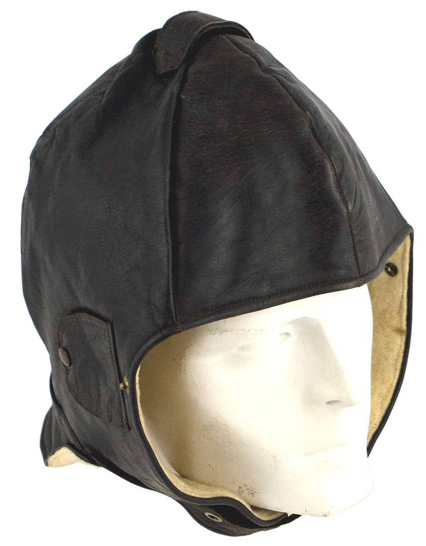 German WWII NSFK Glider Pilot helmet: E-023 German Third-Reich NSFK Glider Pilot helmet. Soft black leather with one top short strap and snap button ear panel covers. Back extended to cover neck. Fleece lined. Excellent slightly used cond
