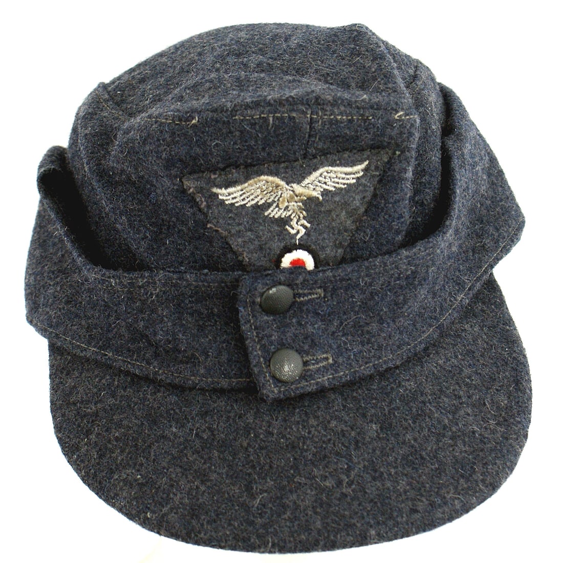 German WWII Luftwaffe EM cap: E-037 German WWII Luftwaffe E.M. cap. Similar to an M-43 but a wartime adoption. Blue-gray wool which also covers both sides of the brim. Flying eagle/swastika/rosette trapezoid embroidered insignia o