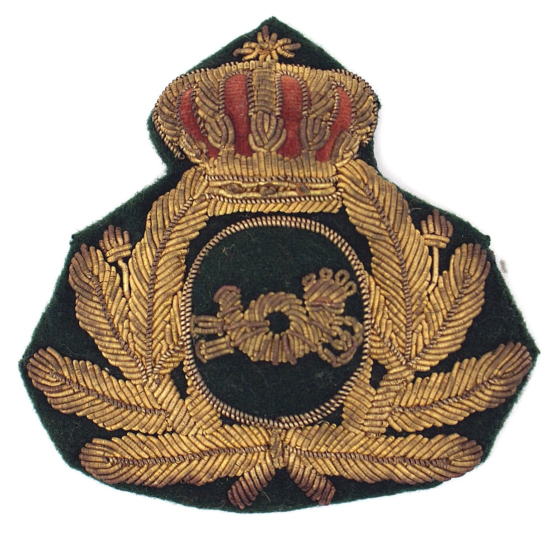 Imperial German peaked cap insignia: E-046 Imperial German high relief embroidered gold bullion peaked cap insignia. Massive age toned crown above an oak leaf wreath - holding an oval raised center panel with a bullion hunting/postal hor