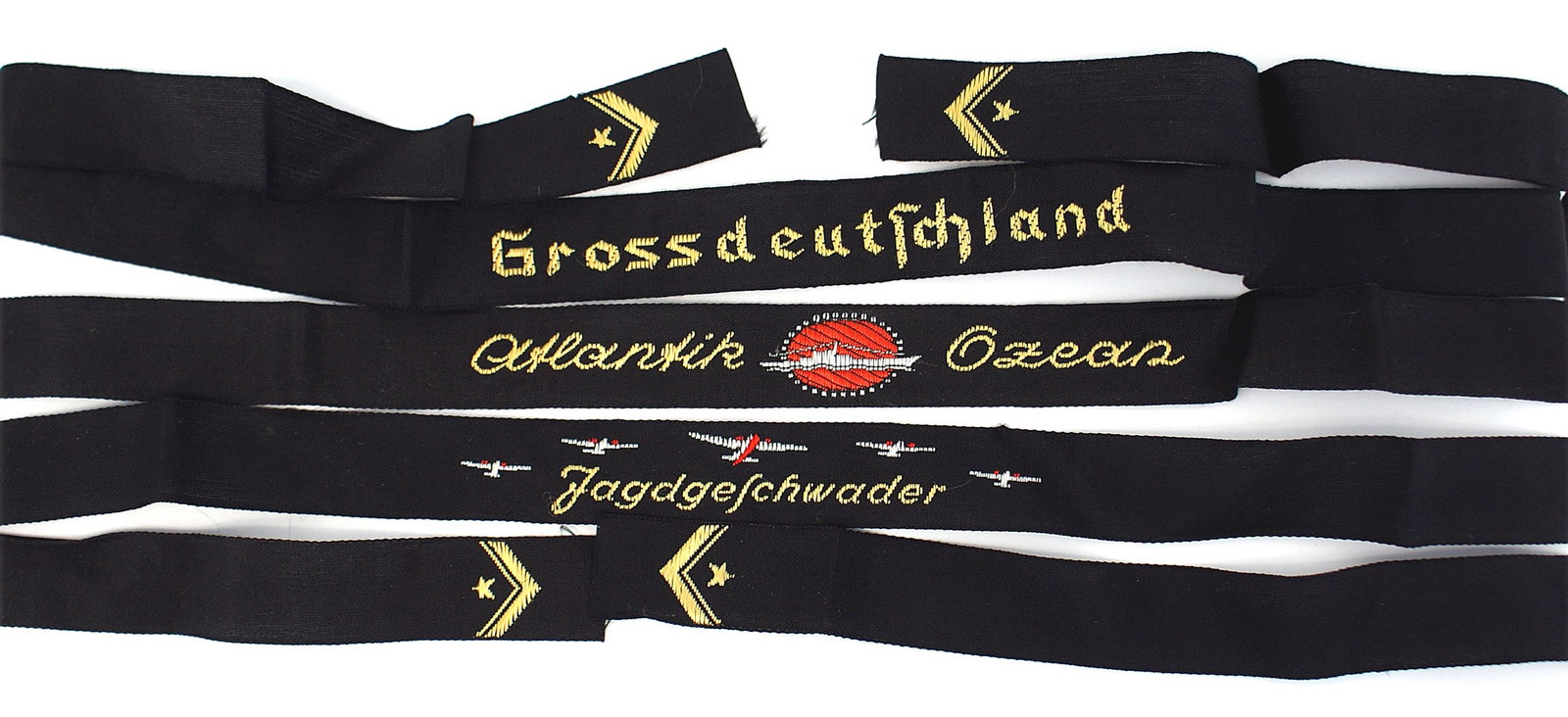 3 German WWII childs Donald Duck cap ribbons: E-053 Lot of 3 German Third-Reich/WWII children's "Donald Duck" cap ribbons: (1) "Atlantic Ozeas" with a submarine on a red oval. (2) "Grossdeutschland". (3) "Jagdgeschwader" with five embroidered air