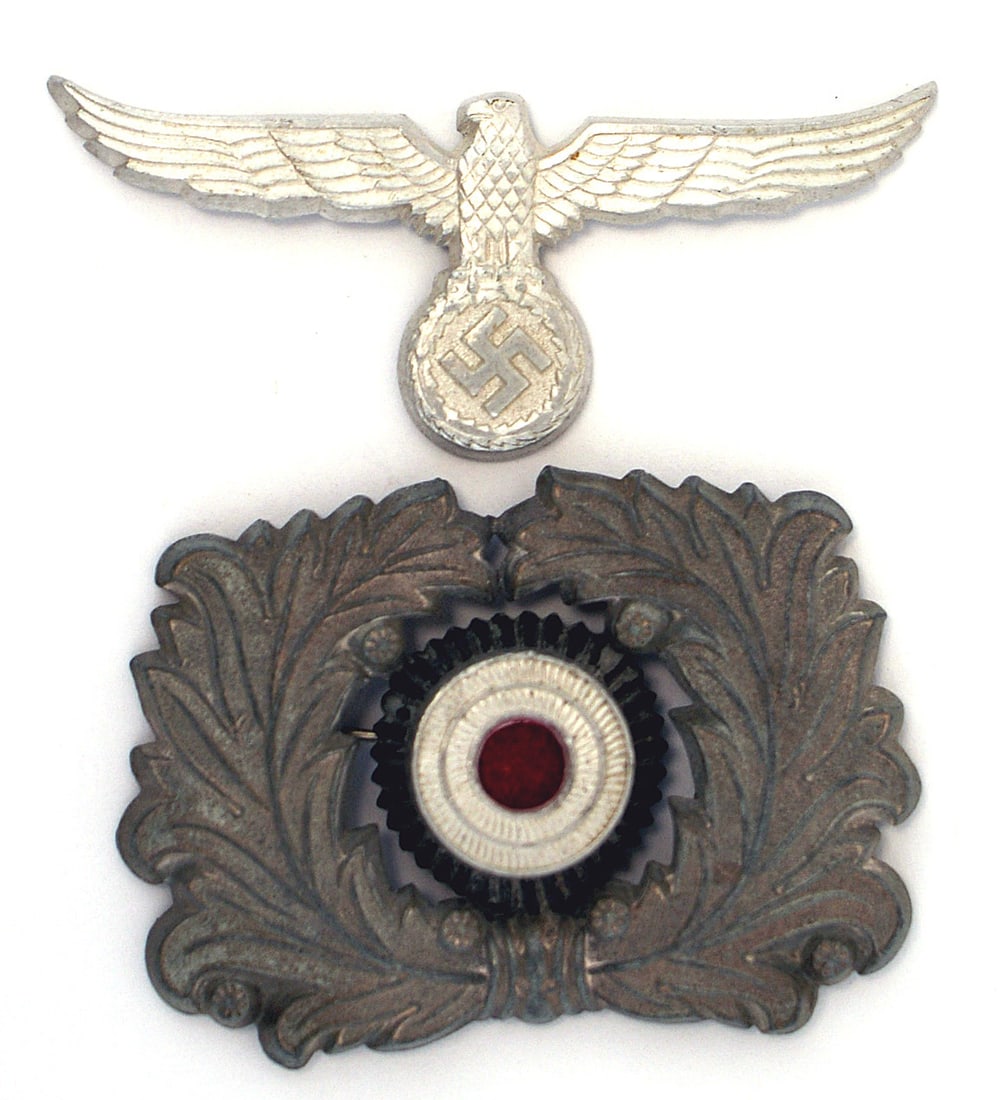 German WWII Land Customs peaked cap insignia: E-056 Third-Reich Land Customs peaked cap insignia. Squared-off wreath and eagle/swastika (with turned upward wing tips). II