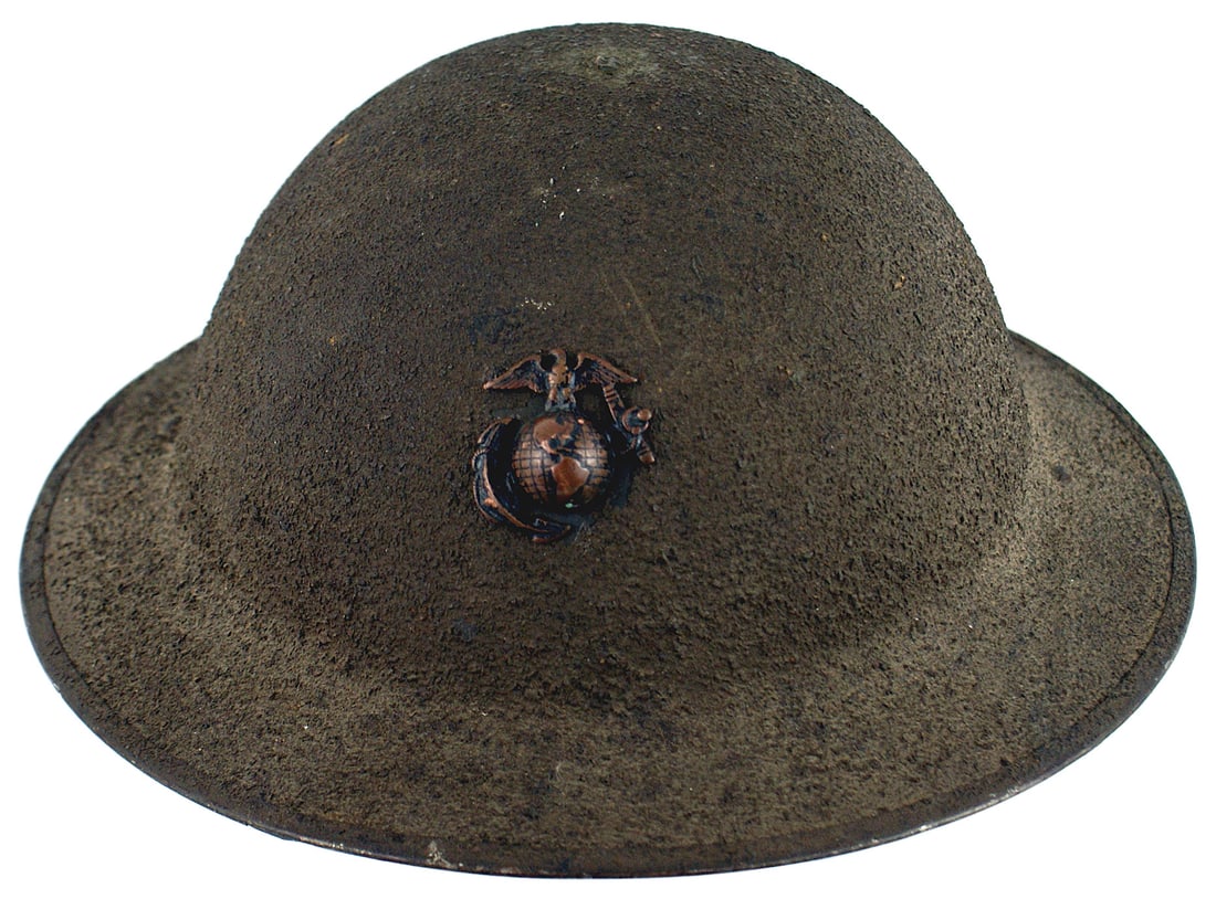 US WWI Marine Corps helmet: E-057 US WWI Marine Corps helmet. O.D. sand finish with the correct EGA badge with both lines of latitude and longitude. With original chinstrap and liner. Paper tag still attached to inside top of he