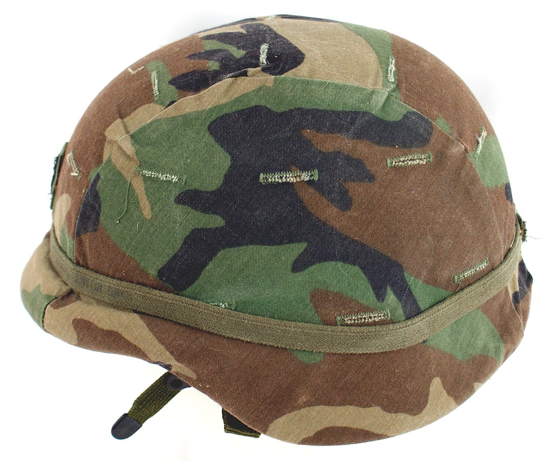 US Army Kevlar M2 helmet: E-061 US Army Kevlar M-2 helmet. With green/brown/tan/black camouflage splotch pattern. Lieutenant's bar on front. Felt/web/leather liner. II+