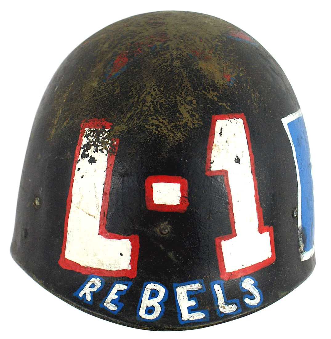 US Rangers decorated helmet liner: E-063 US Rangers decorated helmet liner. Front large "L-1 REBELS", large white outlined blue square with a 5 - point white star and "T-E-X-A-S", "03 Three...and Loaded", and a blue with white star/whi