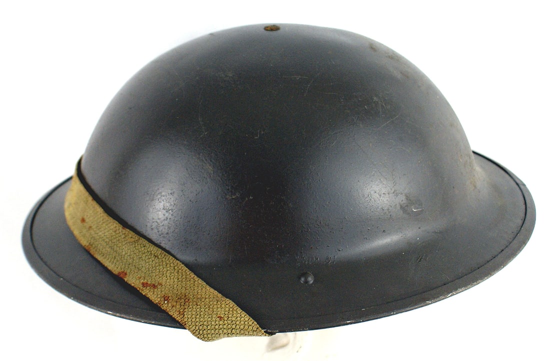 British Canadian WWII type helmet: E-068 British/Canadian WWII type helmet. Smooth O.D. finish. Web chinstrap with a 5 - tongue black leather liner. Appears unused. II+
