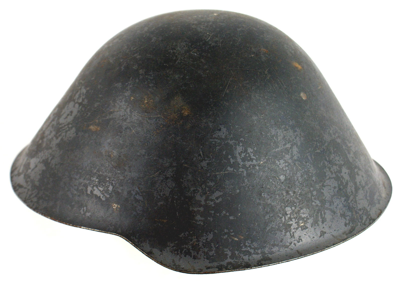 DDR East Germany Army helmet: E-072 DDR (East Germany) Army helmet. Gray-green finish shows some wear. Plastic liner, six leather tongues and two large foam pads. Leather "Y" straps on sides of chinstrap. II