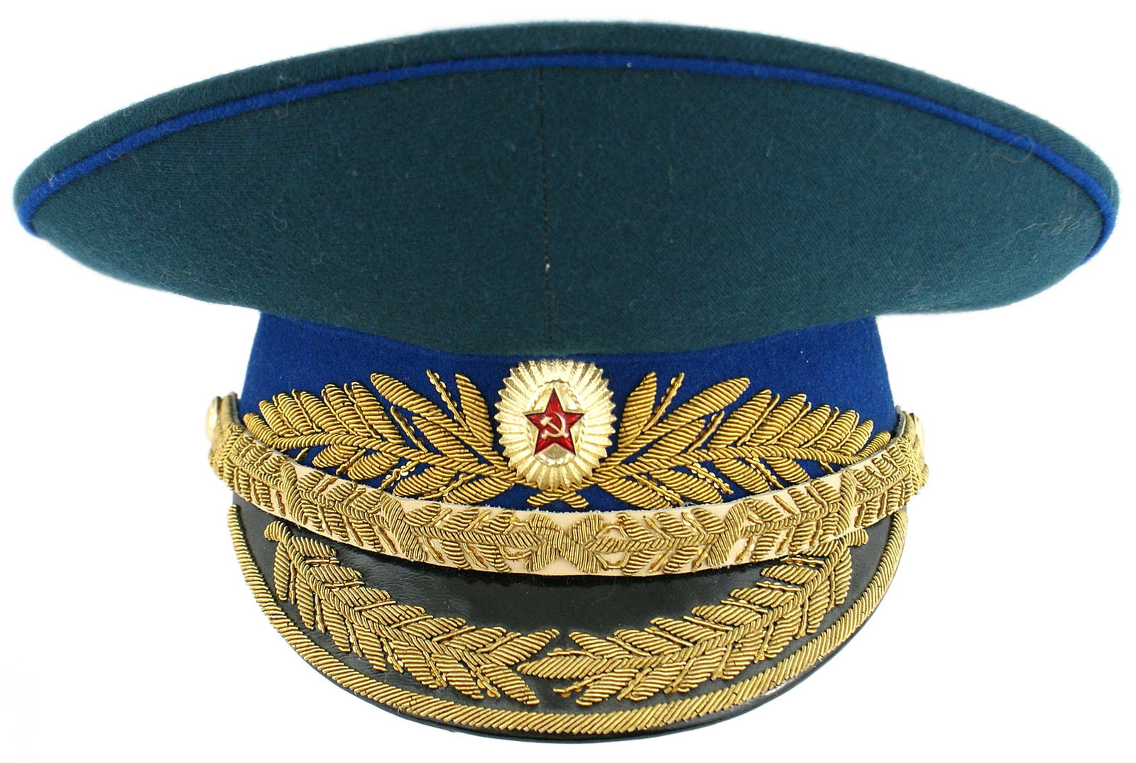 Soviet KGB General peaked parade cap: E-085 Soviet K.G.B. General's peaked parade cap. Leather brim with embroidered gold bullion chinstrap and trim. Gold side buttons. Gilt and enamel cap badge on a blue wool center band with a large row