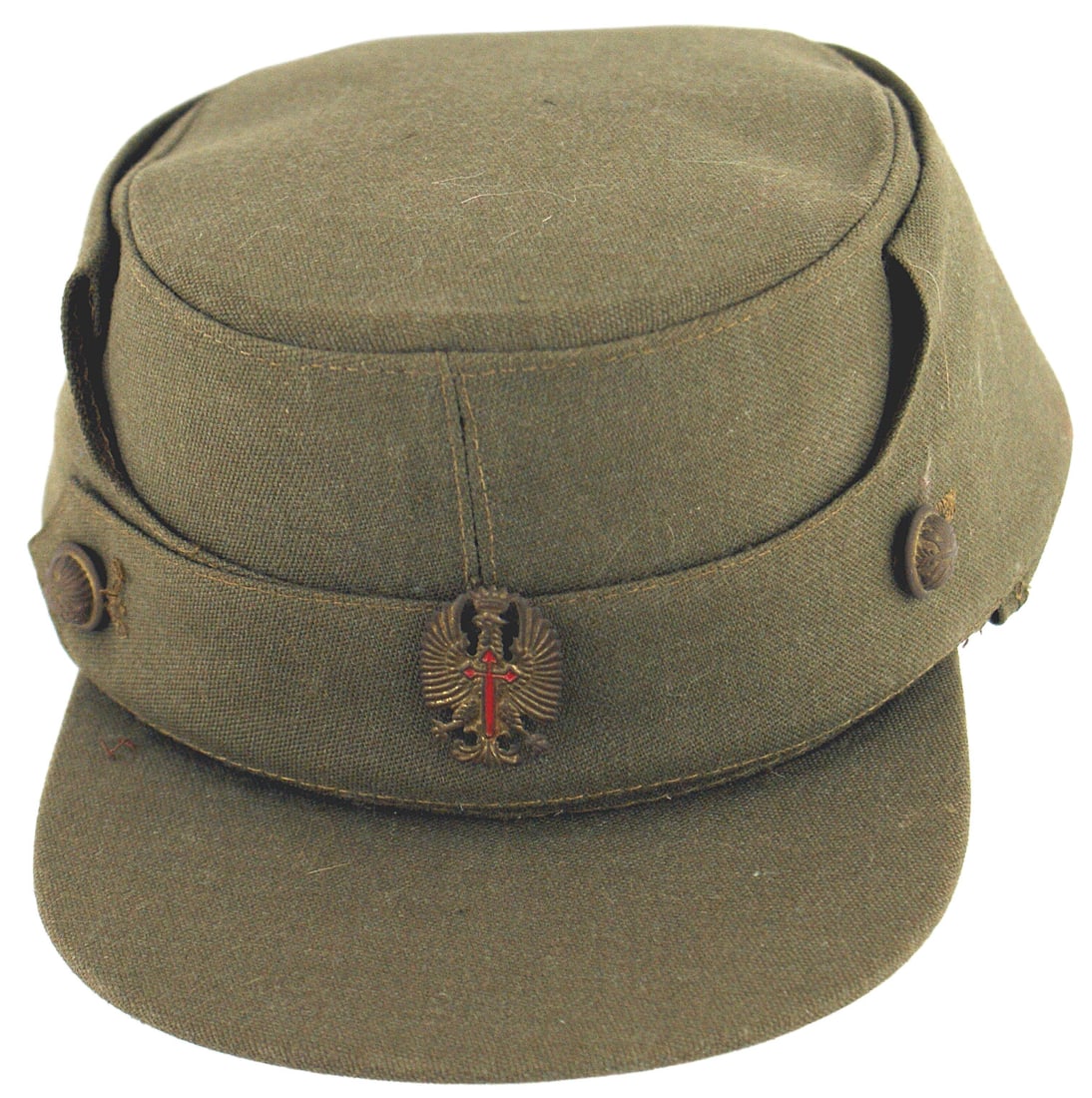 Spanish Falangist Army cap: E-091 Spanish Falangist Army cap, similar to a "coffee can" with a brim. Stiff fabric with two eagle/red cross buttons and a similar cap badge. Brown leather sweat band marked "M. VALLE TOLLA 57". II+