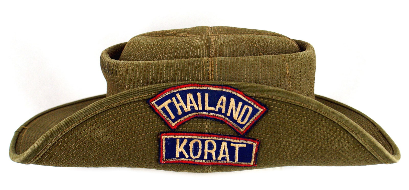Thai ranger service hat KORAT: E-092 Thai Ranger heavy duty service hat. Similar to the Australian hat with a snap-button, turned-up side. With embroidered patches "THAILAND" and "KORAT". Green leather sweat band. II