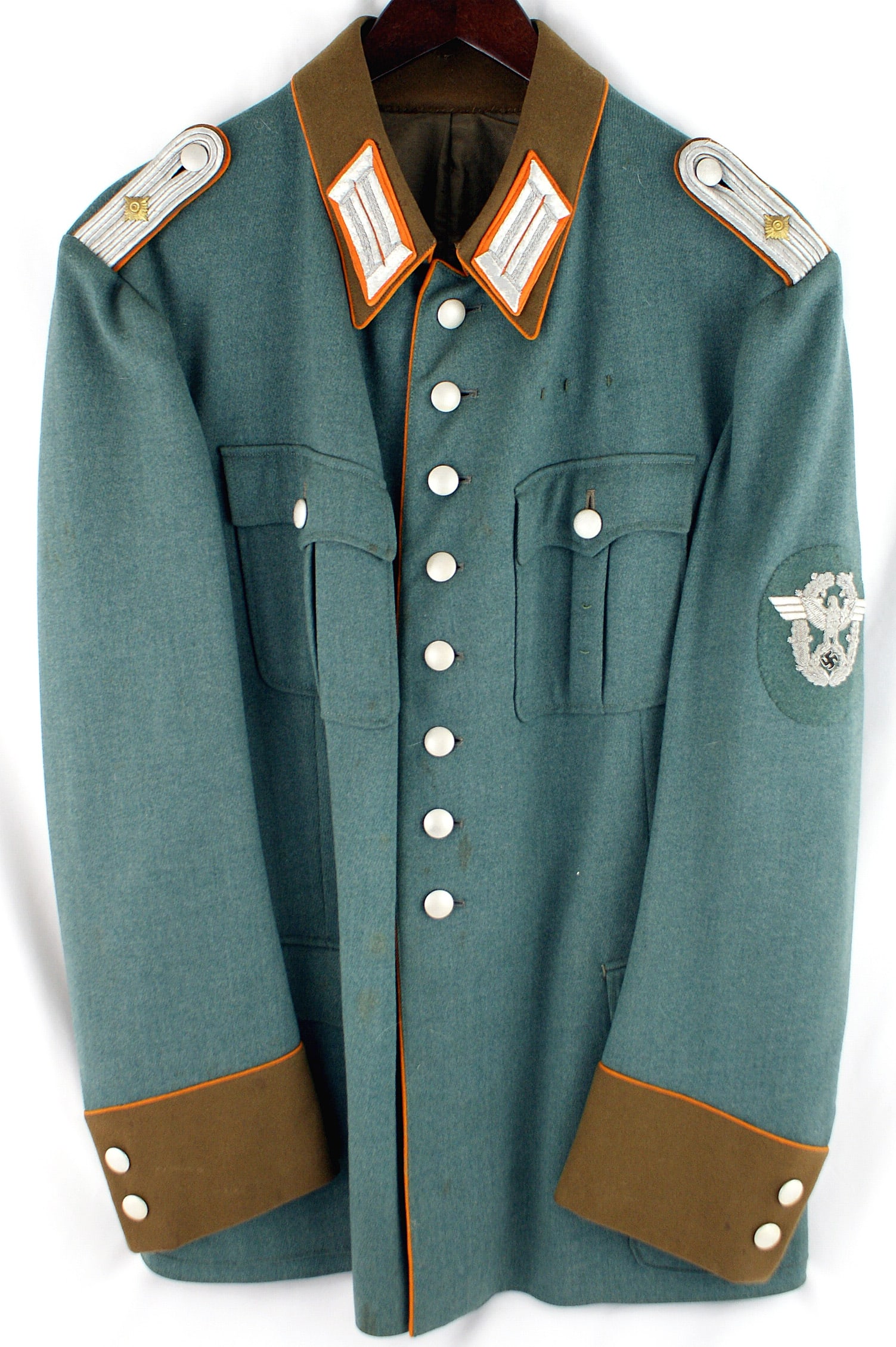 German WWII Police Gendarmerie service tunic: F-005 German Third Reich Police Revierleutnant, Gendarmerie service tunic. Doeskin type, feld grau pockets with eight buttons down front. Orange piped brown collar, cuffs and down front. Embroidered d