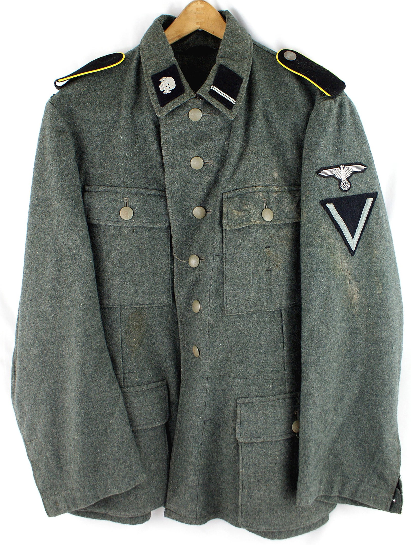 German WWII Waffen SS EM tunic: F-007 German WWII Waffen SS E.M. tunic. (Worn by a member of the "Totekenkopf Verbande" or the 3rd SS Panzer Division "Totenkopf") . Made of feldgrau "ersatz" wool. Late war. Flat silver SS eagle on l