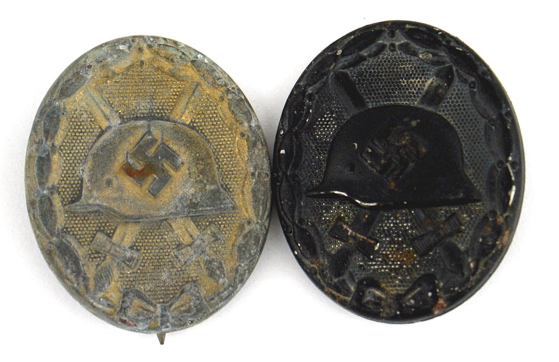 2 German WWII Wound Badges Black Gold: B-064 Lot of 2 German WWII Wound Badges: (1) Black. Relief swastika on helmet, with crossed swords. II (2) Gold. Most of the gold finish is worn, however plenty of aged gold residue on the helmet, swa