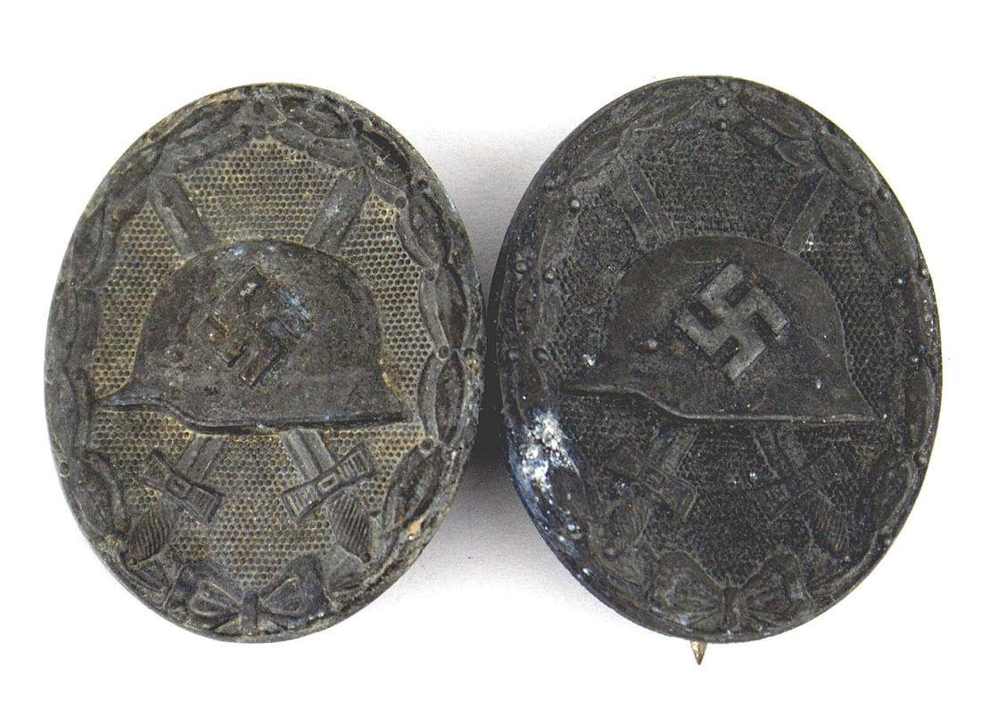 2 German WWII Silver Wound Badges: B-065 Lot of 2 German WWII Wound Badges - Silver. Rust on pin/catch of one badge. II