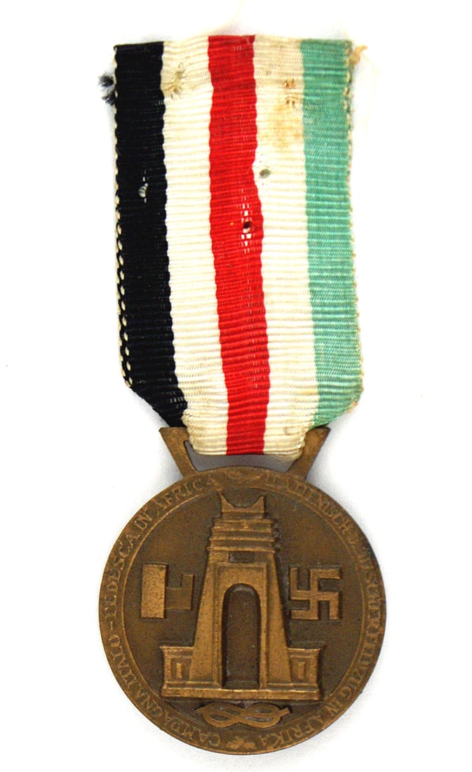 German WWII medal African Campaign Bronze: B-067 German WWII medal for the African Campaign in Bronze. Obverse bears a relief of two soldiers (German and Italian) doing battle with a crocodile. Reverse has a swastika and fasces next to the Fel