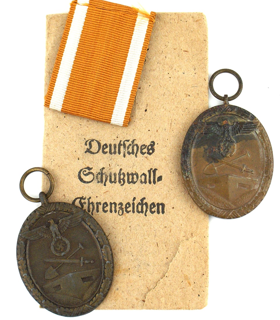 2 German WWII West Wall Medals: B-071 Lot of 2 German WWII West Wall Medals. Large eagle/swastika, crossed shovel/sword - over a bunker. Awarded to all personnel who helped construct Germany's "West Wall" fortification. (1) Medal wi